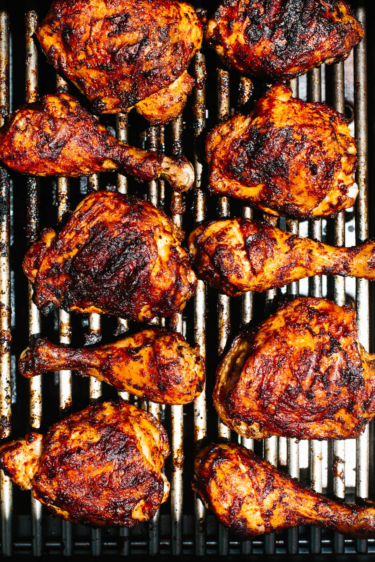 This BBQ chicken is insanely juicy, perfectly charred, and glistening with my secret homemade BBQ sauce. Perfect for your summer cookout! BBQ chicken on a grill