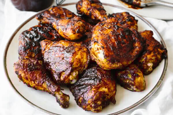 BBQ chicken piled on a white plate