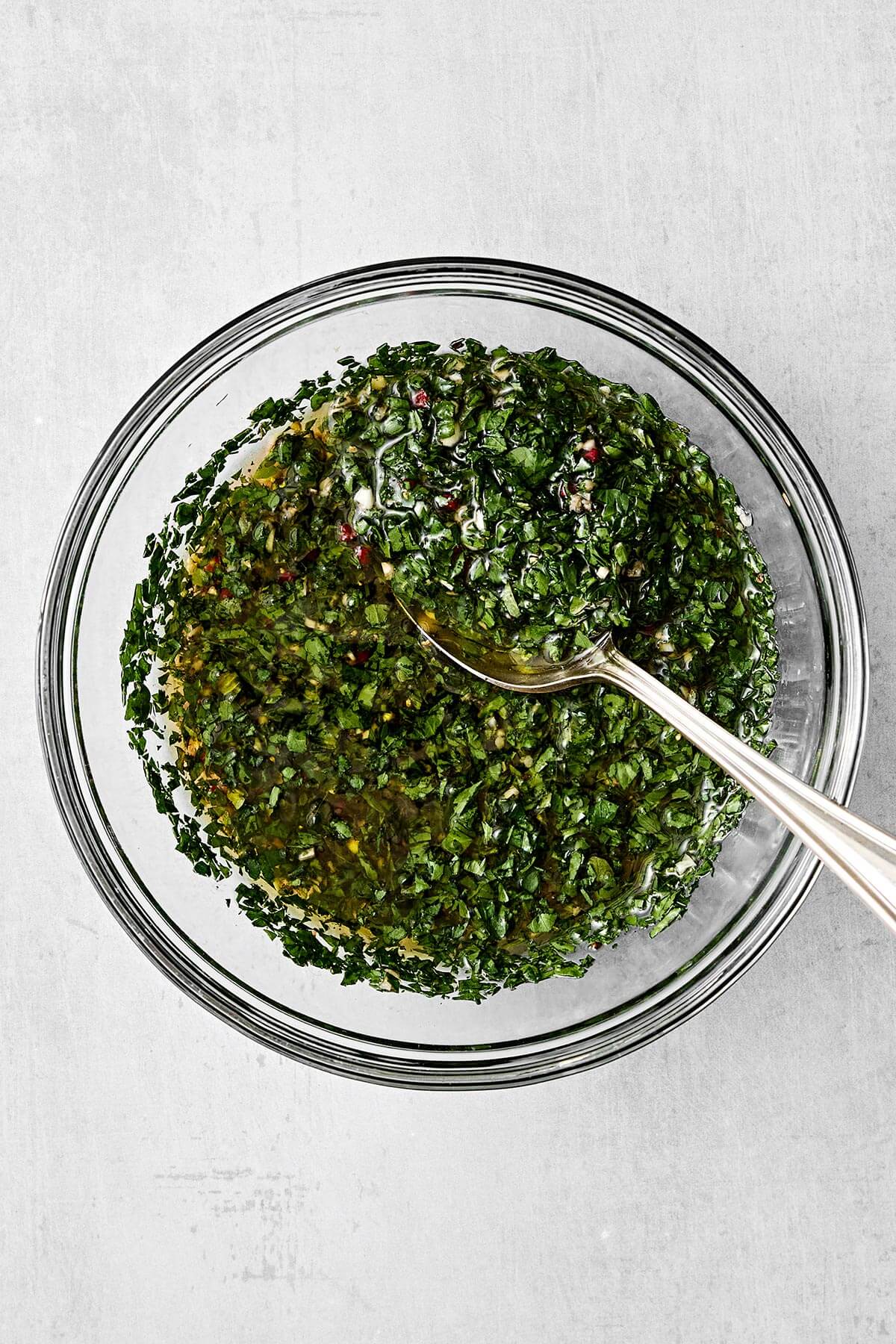 Fresh chimichurri sauce in a bowl.