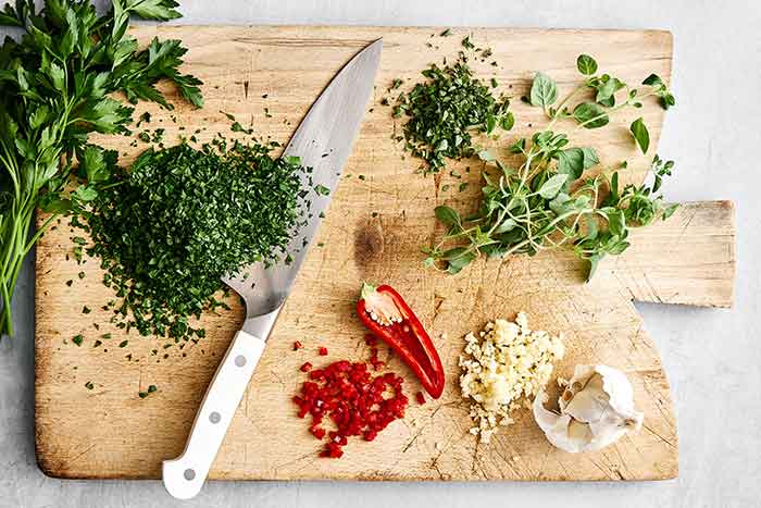 Chopped chimichurri sauce ingredients.