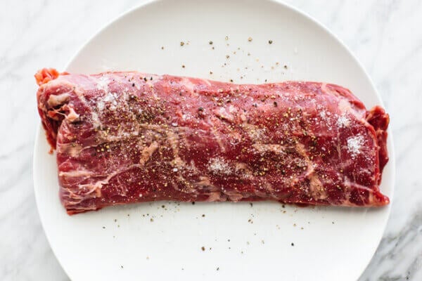Raw piece of skirt steak on a plate
