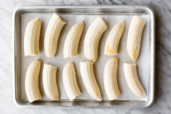 Frozen banana pieces on a baking tray