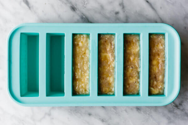 A silicone tray with frozen mashed bananas