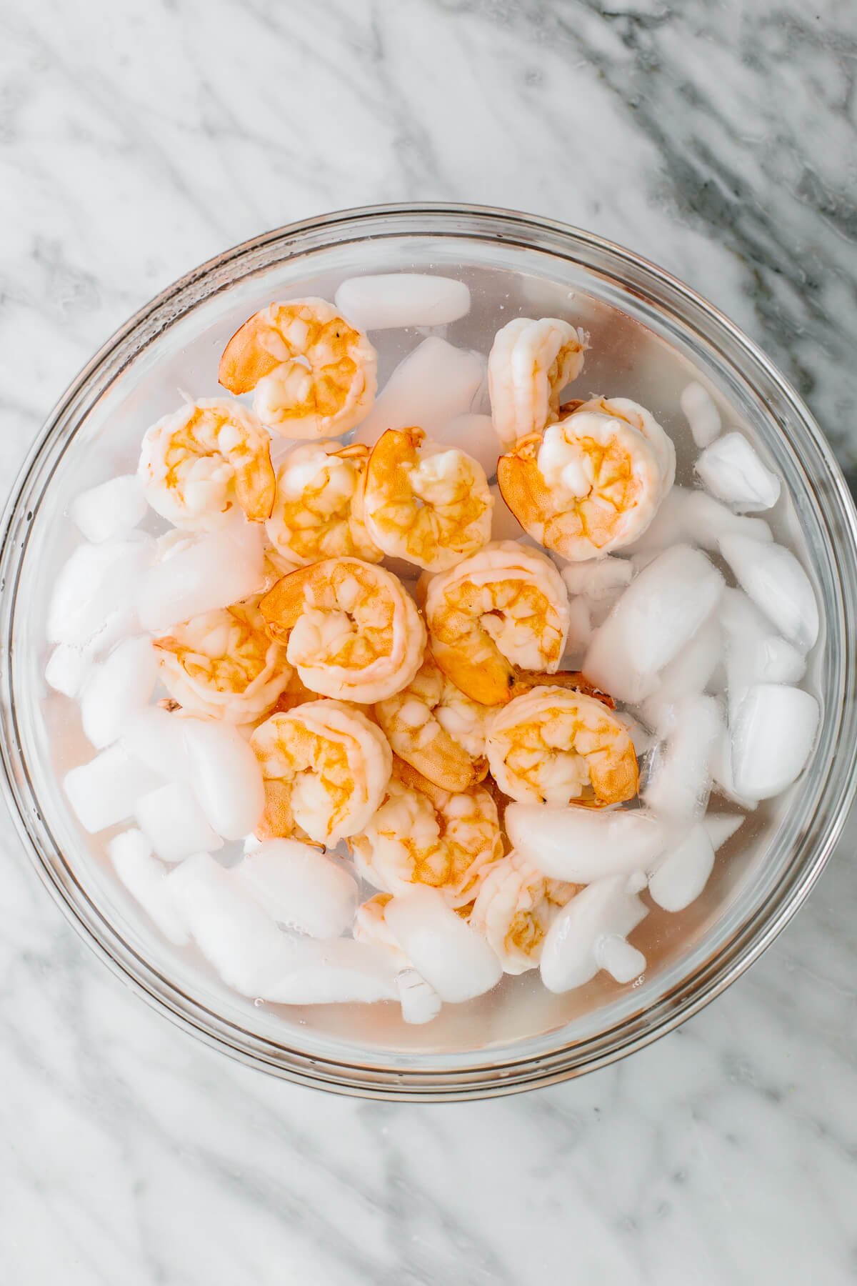This cucumber shrimp salad is everything you love about an easy and healthy salad recipe, but with a fresh twist! Chilling shrimp in a bowl for cucumber shrimp salad