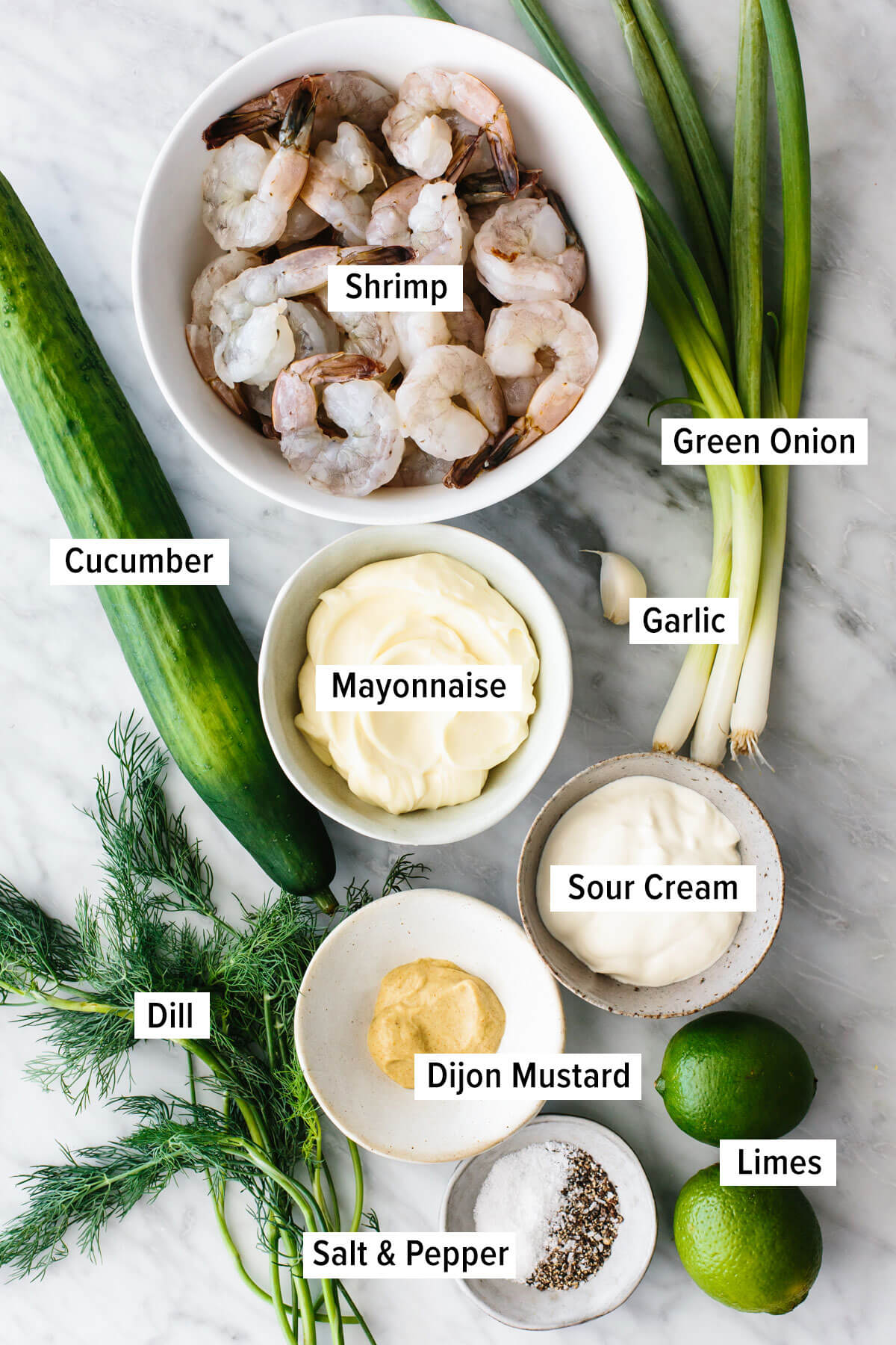 This cucumber shrimp salad is everything you love about an easy and healthy salad recipe, but with a fresh twist! Ingredients for cucumber shrimp salad on a table
