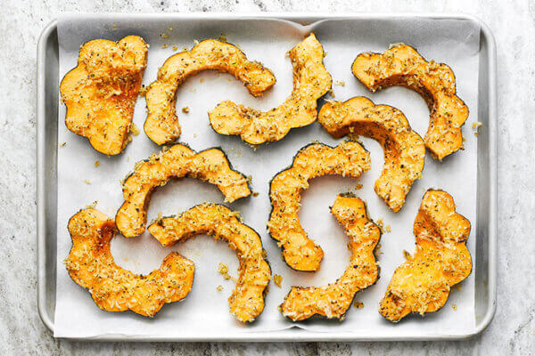 Roasted acorn squashes on a baking tray