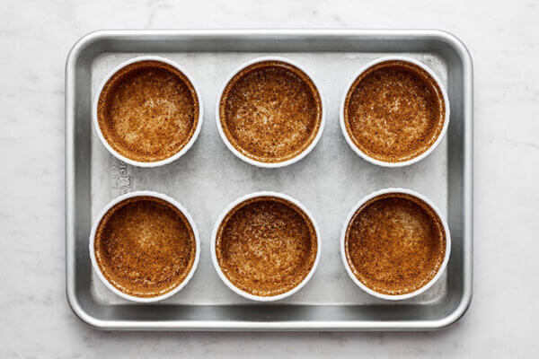 Ramekins prepped for spiced pear souffles