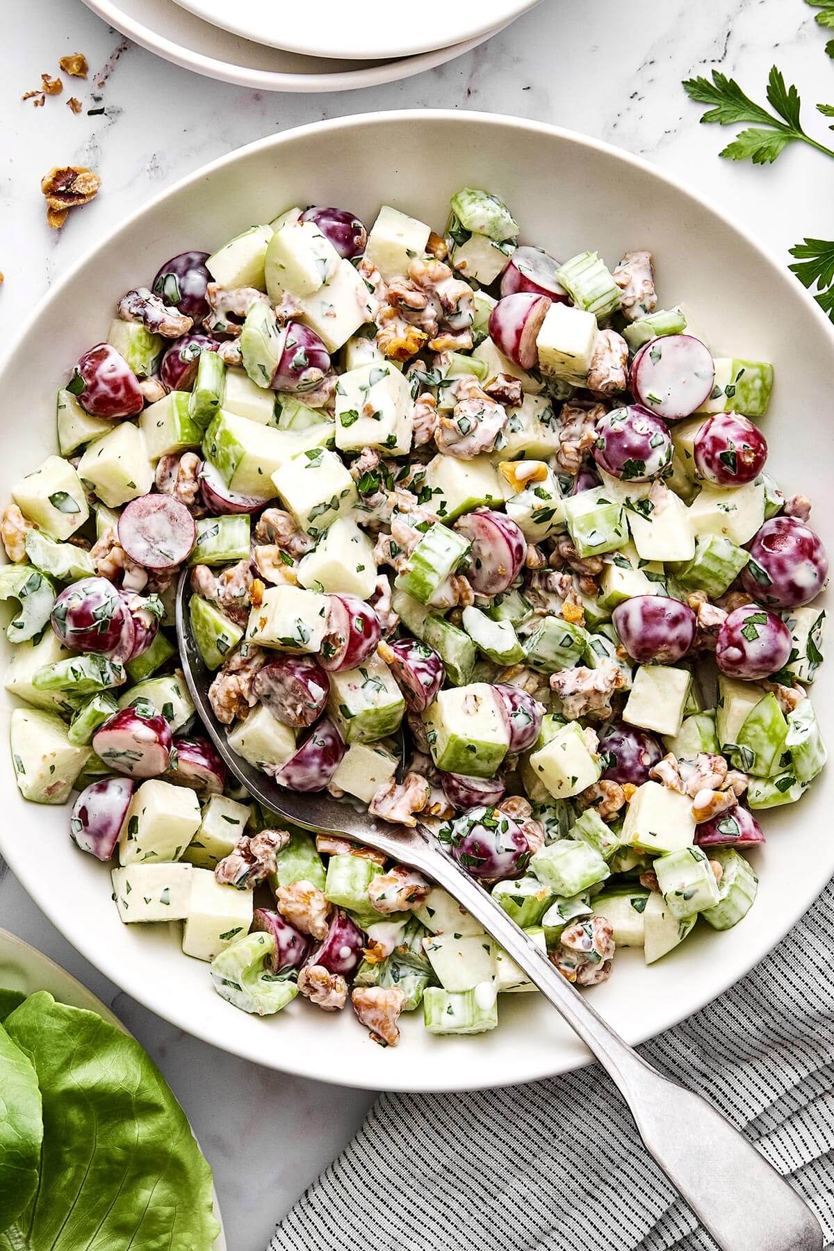 Everyone will love this classic Waldorf salad for holiday dinners! It's crisp, refreshing, and tossed in the best creamy dressing. A bowl of Waldorf salad.
