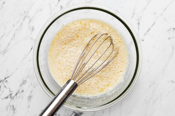 Whisking wet ingredients for berry baked oatmeal
