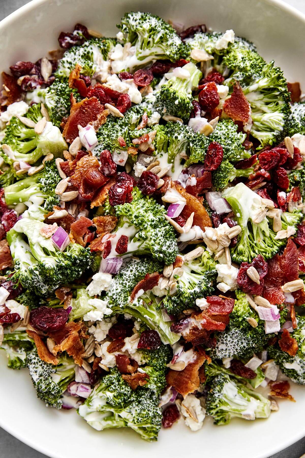 Everyone loves this broccoli salad recipe! With bacon, cranberries, and a creamy dressing, it's the perfect party side dish. Broccoli salad side dish.