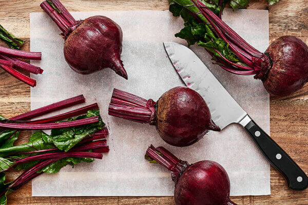 Prepping beets on a cutting board before roasting