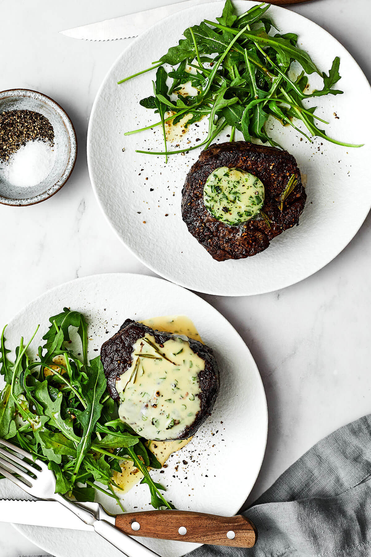 Plates of filet mignon and a salad
