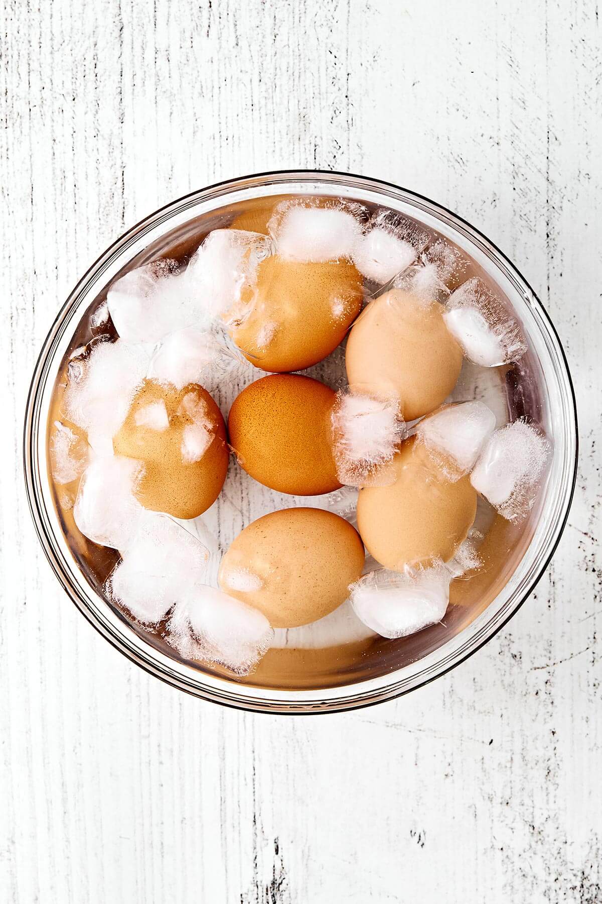 This is the classic deli-style egg salad we all know and love—perfectly creamy, delightfully chunky, and filled with fresh flavors. Chilled eggs in a bowl of ice.
