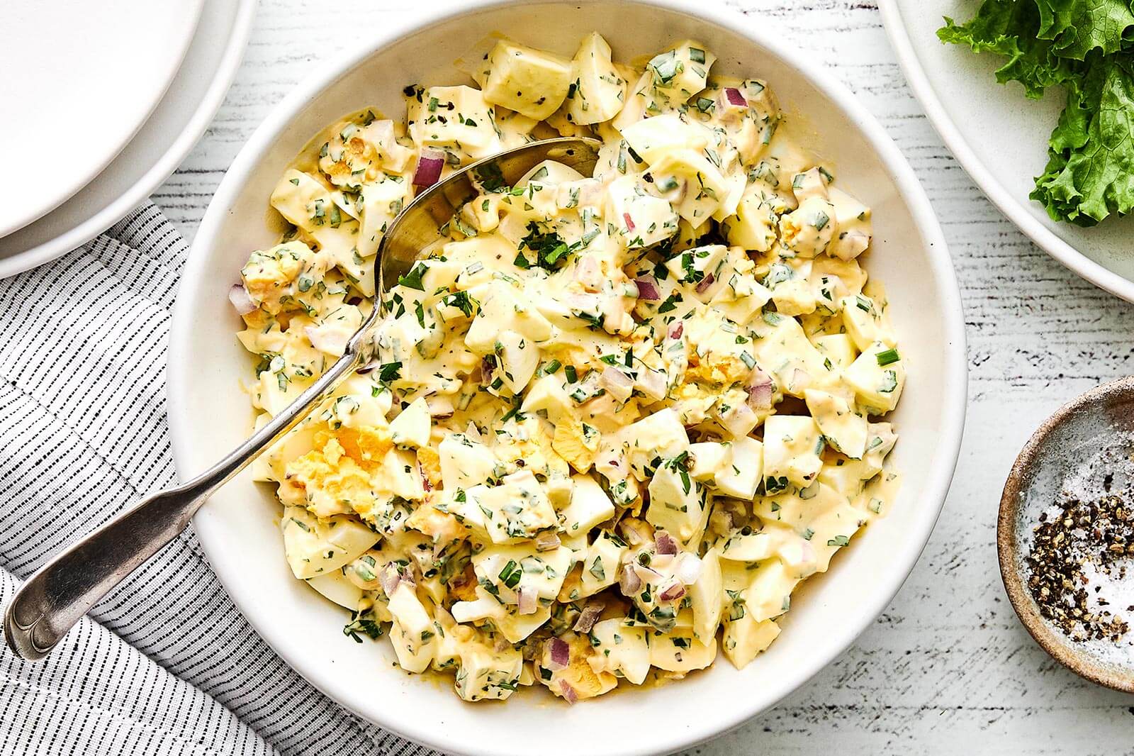 A white bowl of egg salad.