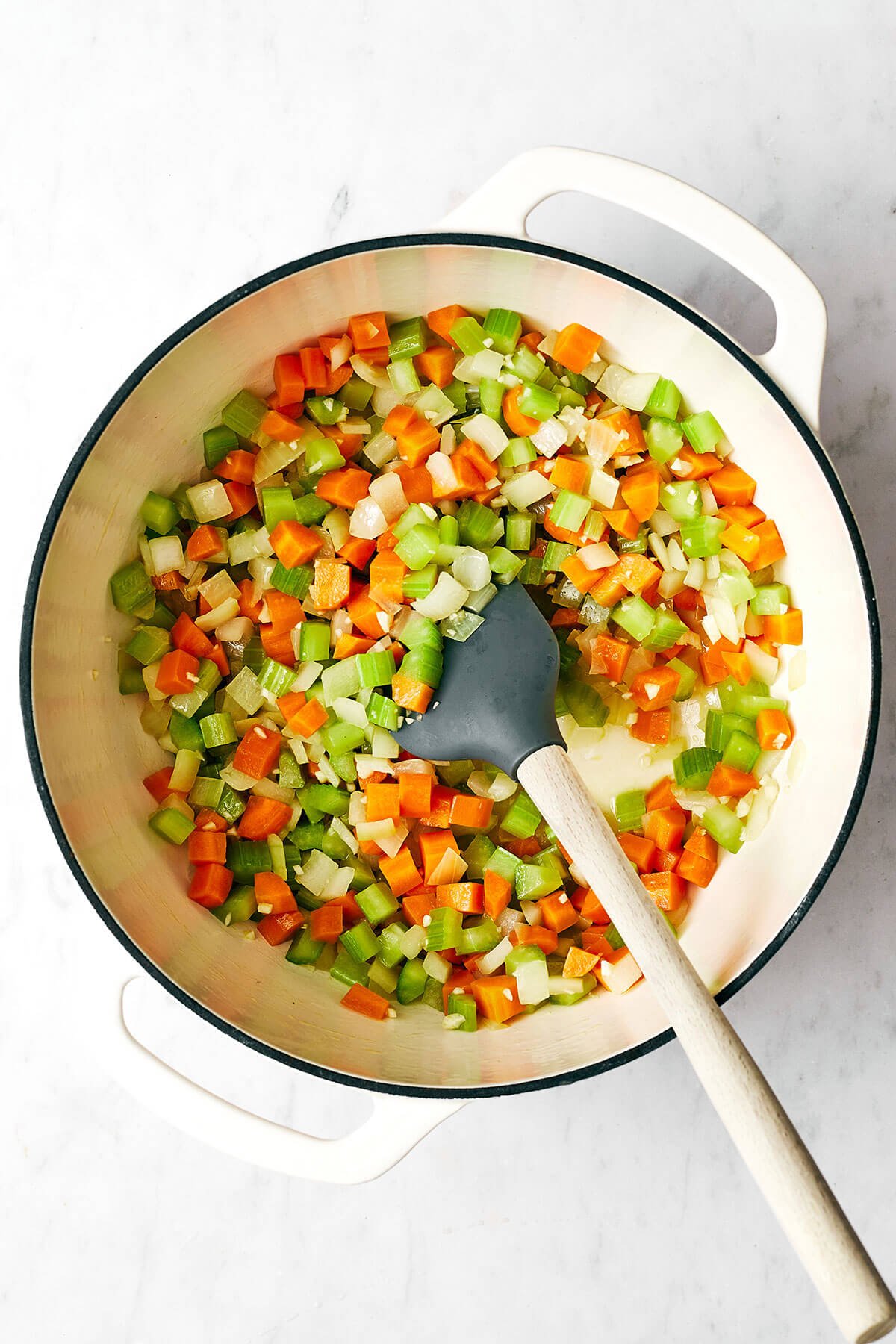 This split pea soup made with a ham bone is the best leftover ham recipe from the holidays! Cooking vegetables in a pot for split pea soup