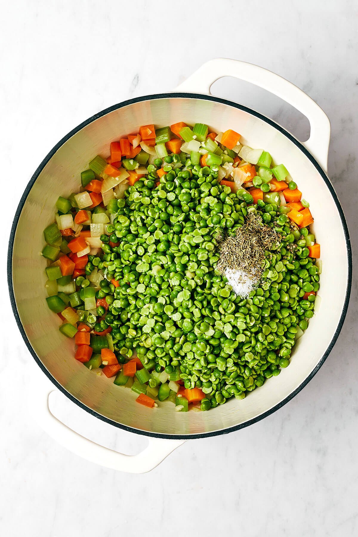 This split pea soup made with a ham bone is the best leftover ham recipe from the holidays! Adding split pea soup ingredients into a pot