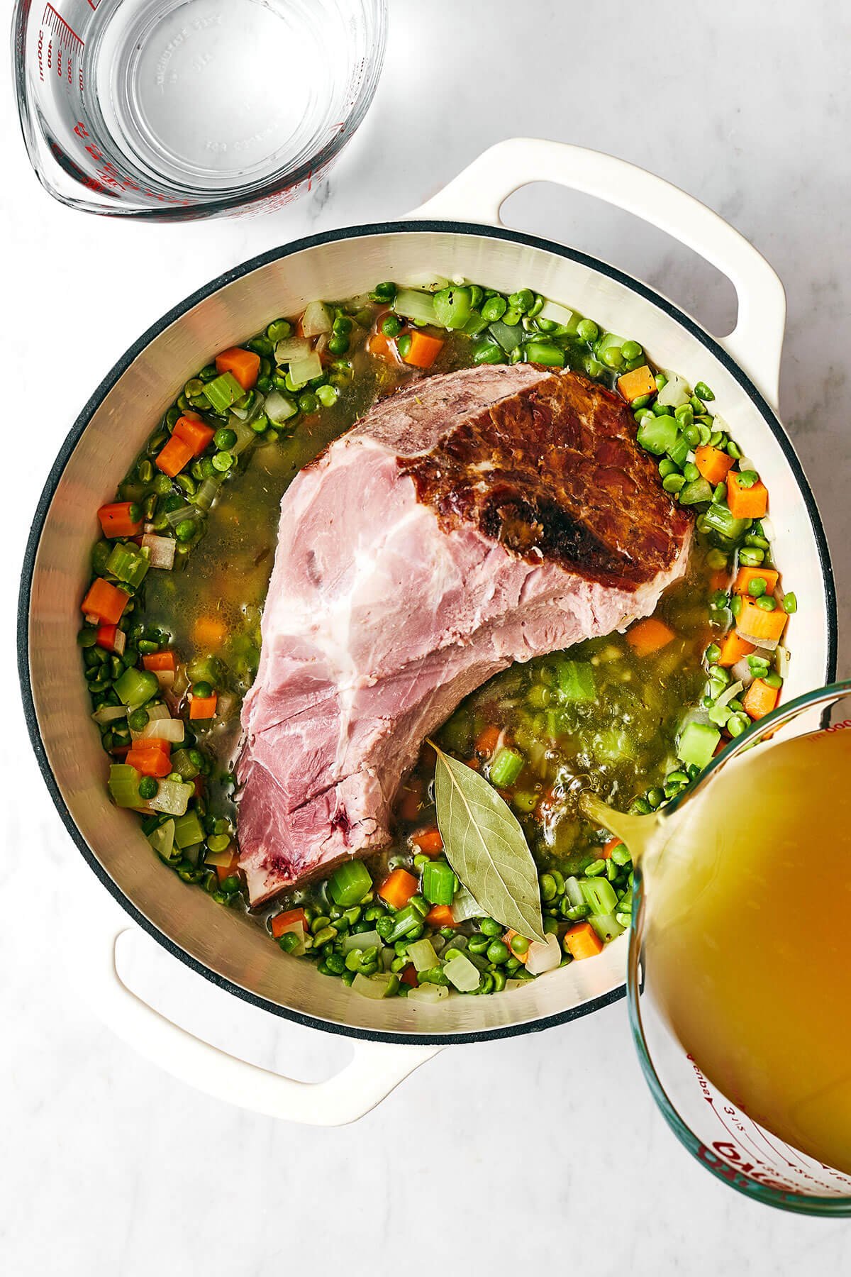 This split pea soup made with a ham bone is the best leftover ham recipe from the holidays! Adding a ham bone into a pot of split pea soup