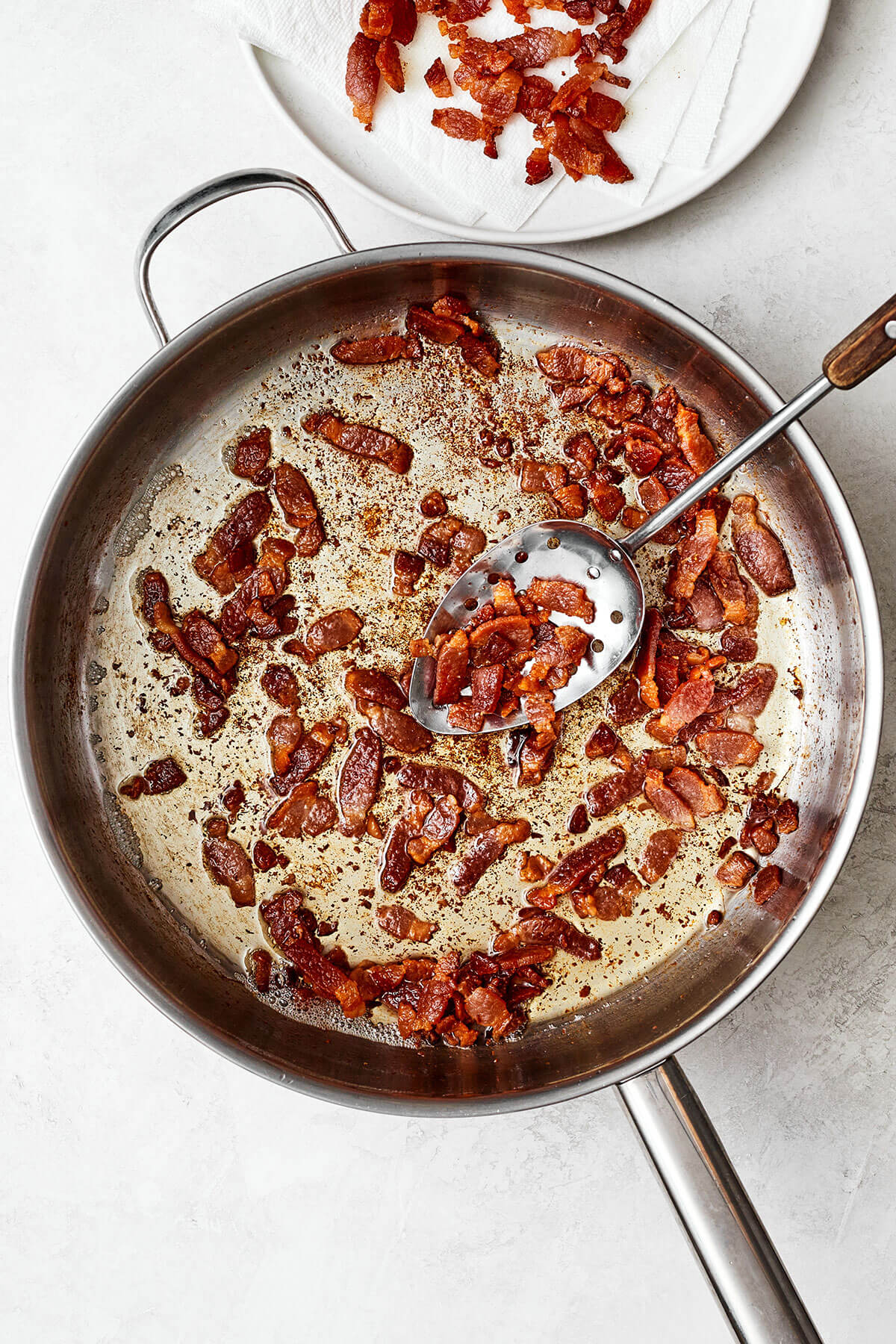 Cooking bacon in a pan for German potato salad