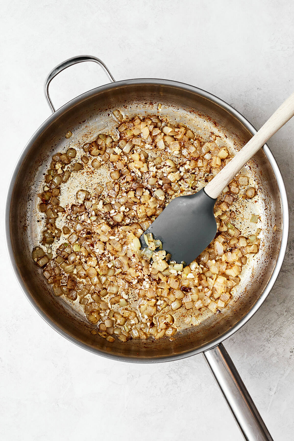 Cooked onions in a pan for German potato salad