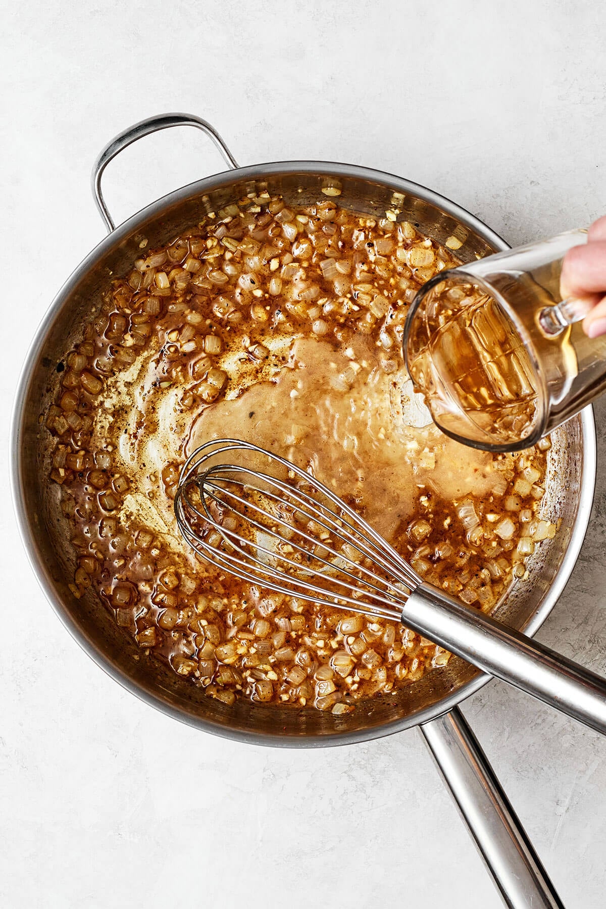 Making sauce in pot for German potato salad