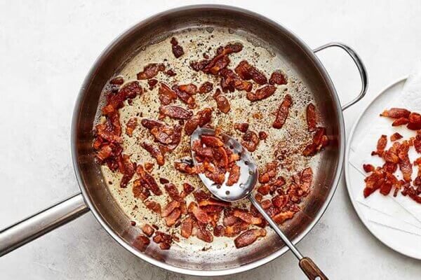 Cooked bacon bits in a pan for German potato salad