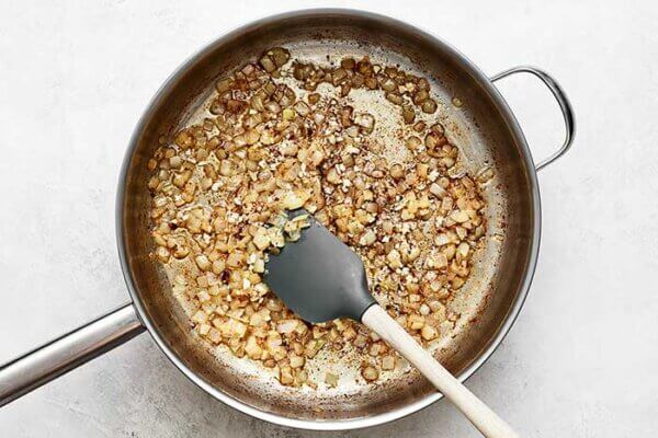 Cooked onions in a pan for German potato salad
