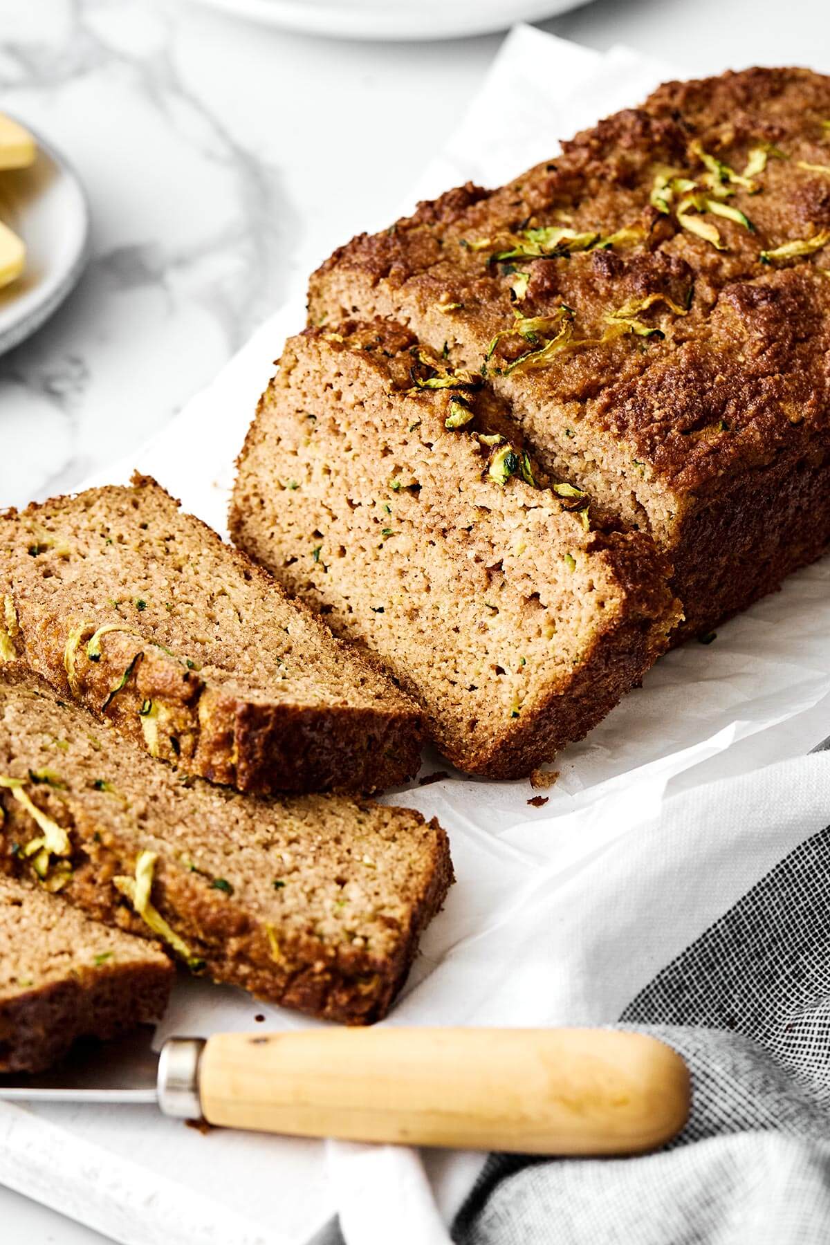 This gluten-free zucchini bread is the kind of loaf you’ll want to keep on your counter all summer long. It’s perfectly moist, gently spiced, and sneaks in a little veggie boost to your morning breakfast. Slices of gluten-free zucchini bread.