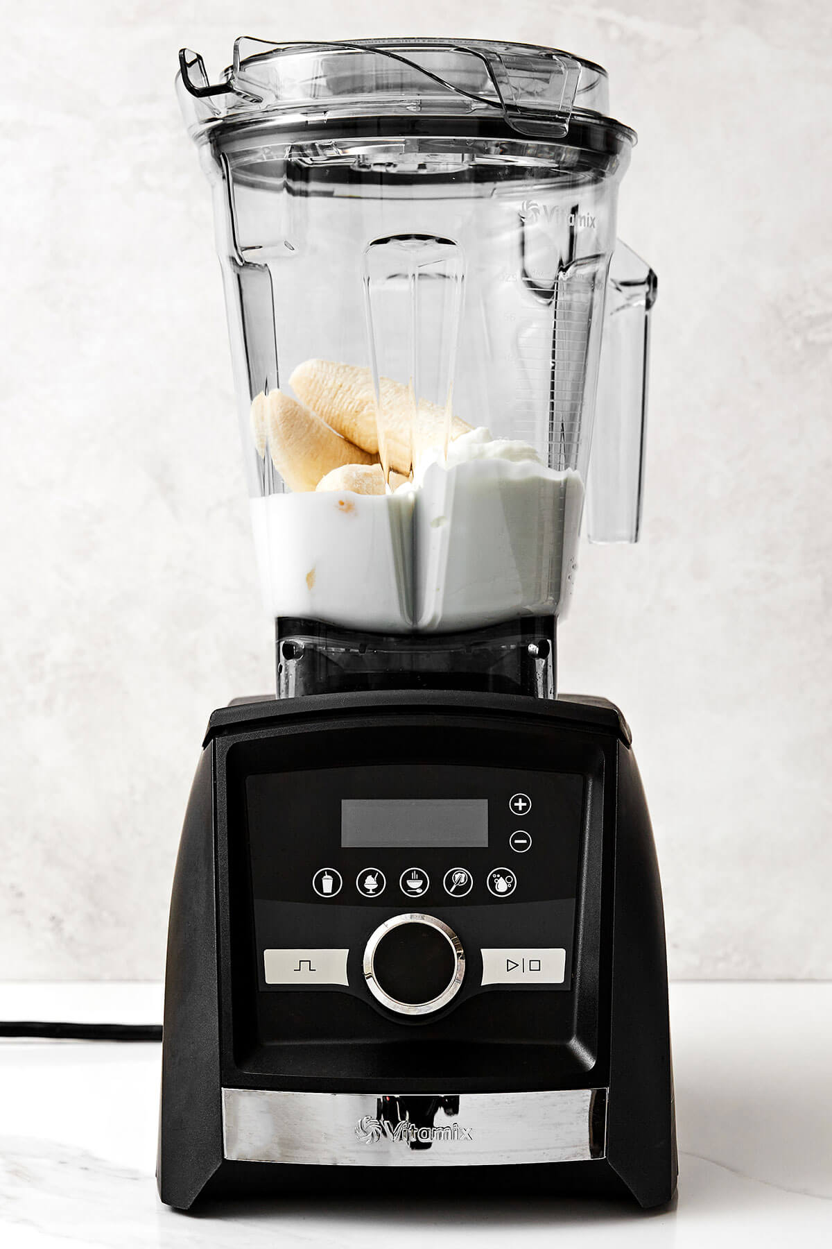 My favorite 3-ingredient banana smoothie recipe! It's simple yet tasty with frozen bananas, a milk of your choice, and Greek yogurt. Banana smoothie ingredients in blender