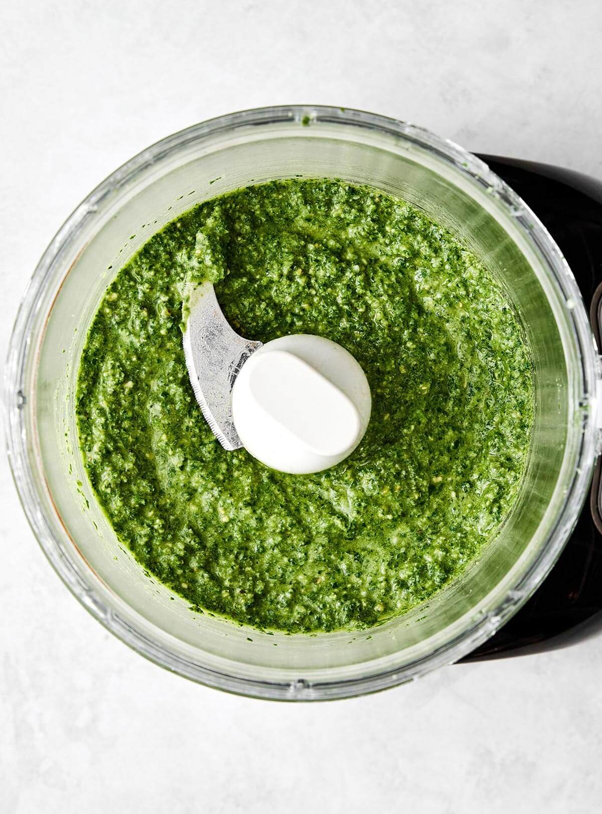 Flavorful and aromatic, this basil pesto is the best summer sauce to slather on anything! Plus, it comes together in 15 minutes. Blending basil pesto sauce.