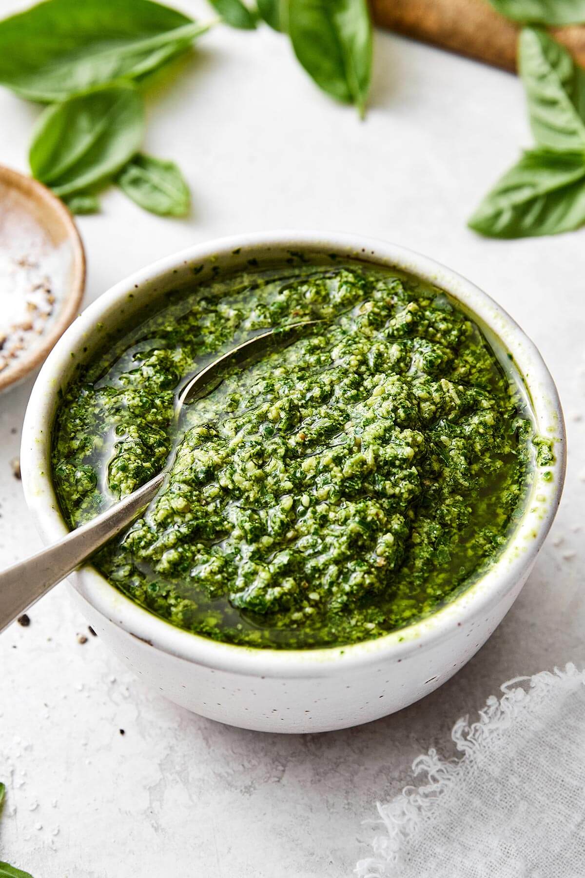 Flavorful and aromatic, this basil pesto is the best summer sauce to slather on anything! Plus, it comes together in 15 minutes. A bowl basil pesto sauce.