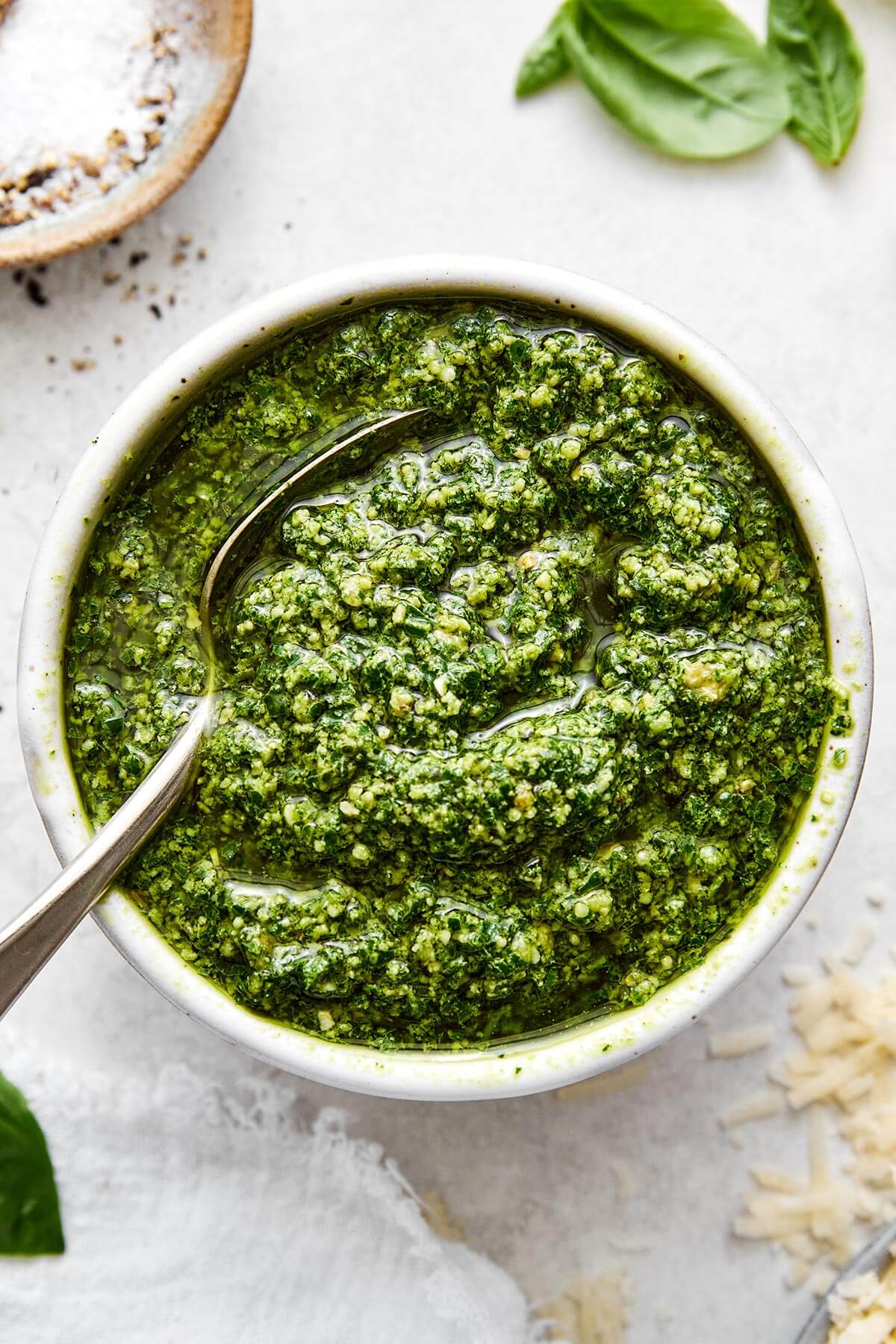 Flavorful and aromatic, this basil pesto is the best summer sauce to slather on anything! Plus, it comes together in 15 minutes. A bowl of fresh basil pesto sauce.