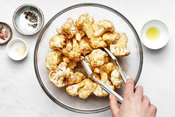 Mixing cauliflower with seasonings