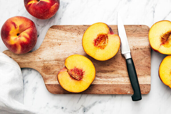 Sliced peach on a board