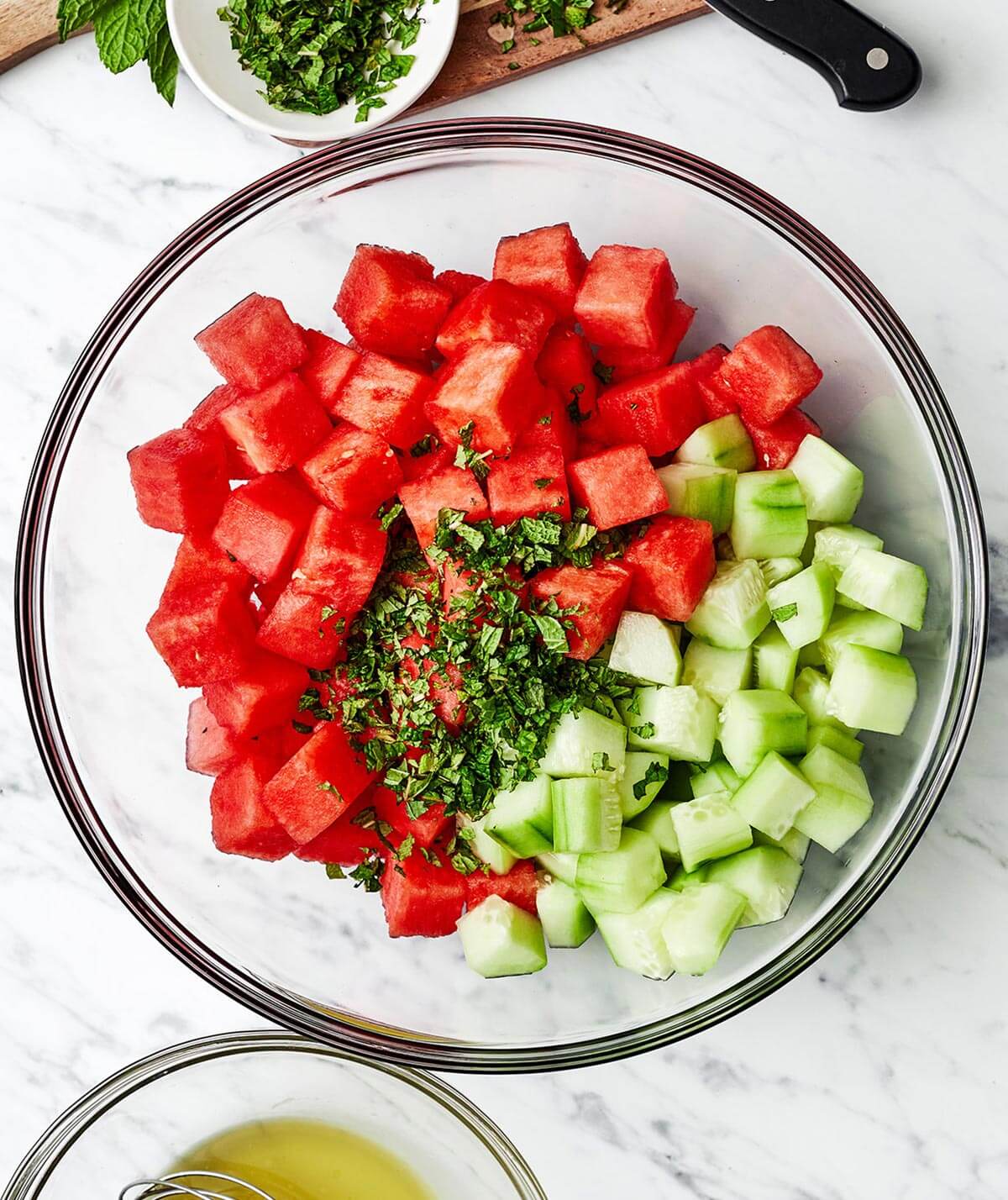 Watermelon salad ingredients in a bowl.
