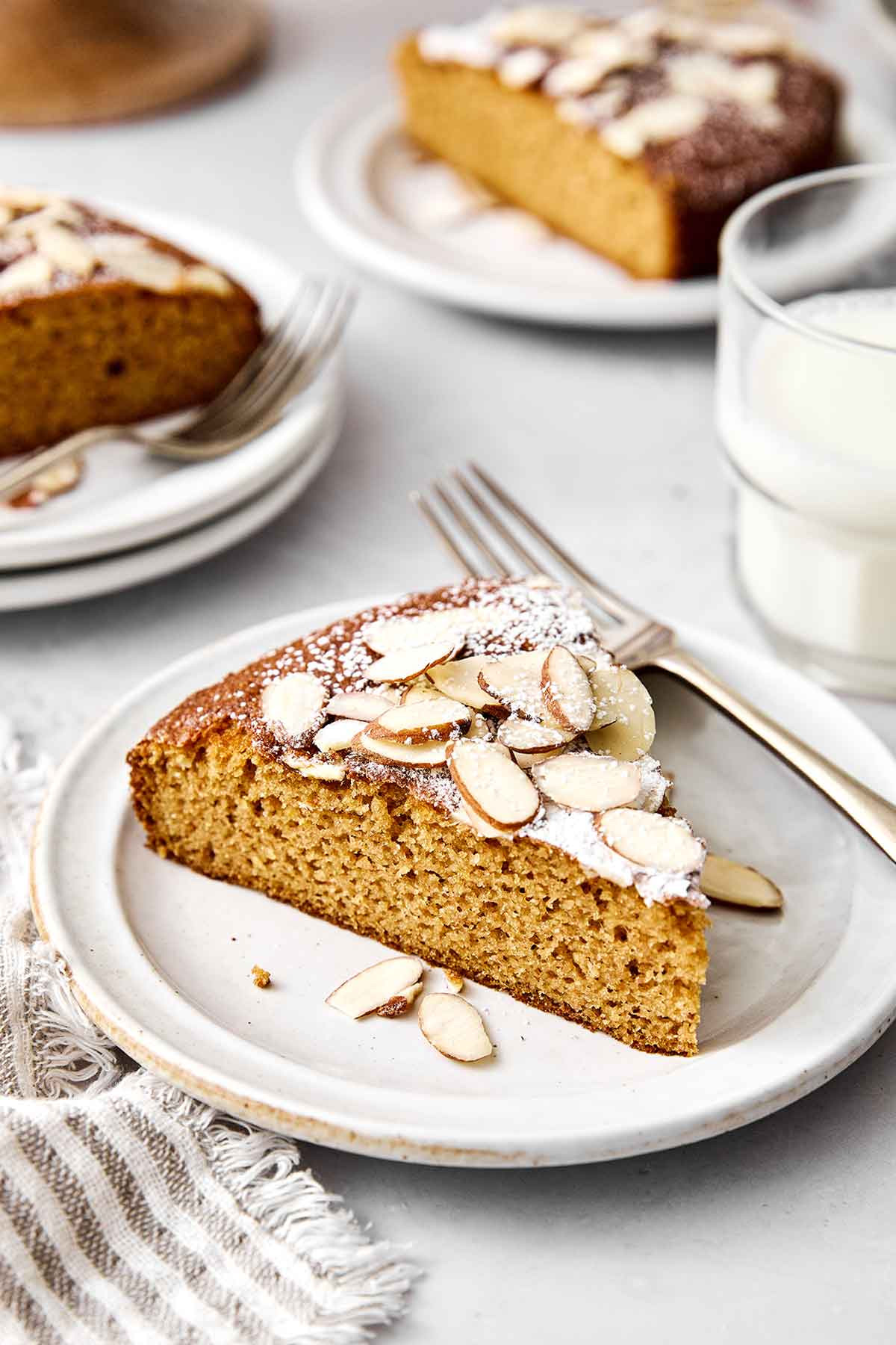 This almond cake is the perfect dessert for any occasion. Serve it plain for afternoon tea or top it with cream and fruit for the holidays! Slices of almond cake.