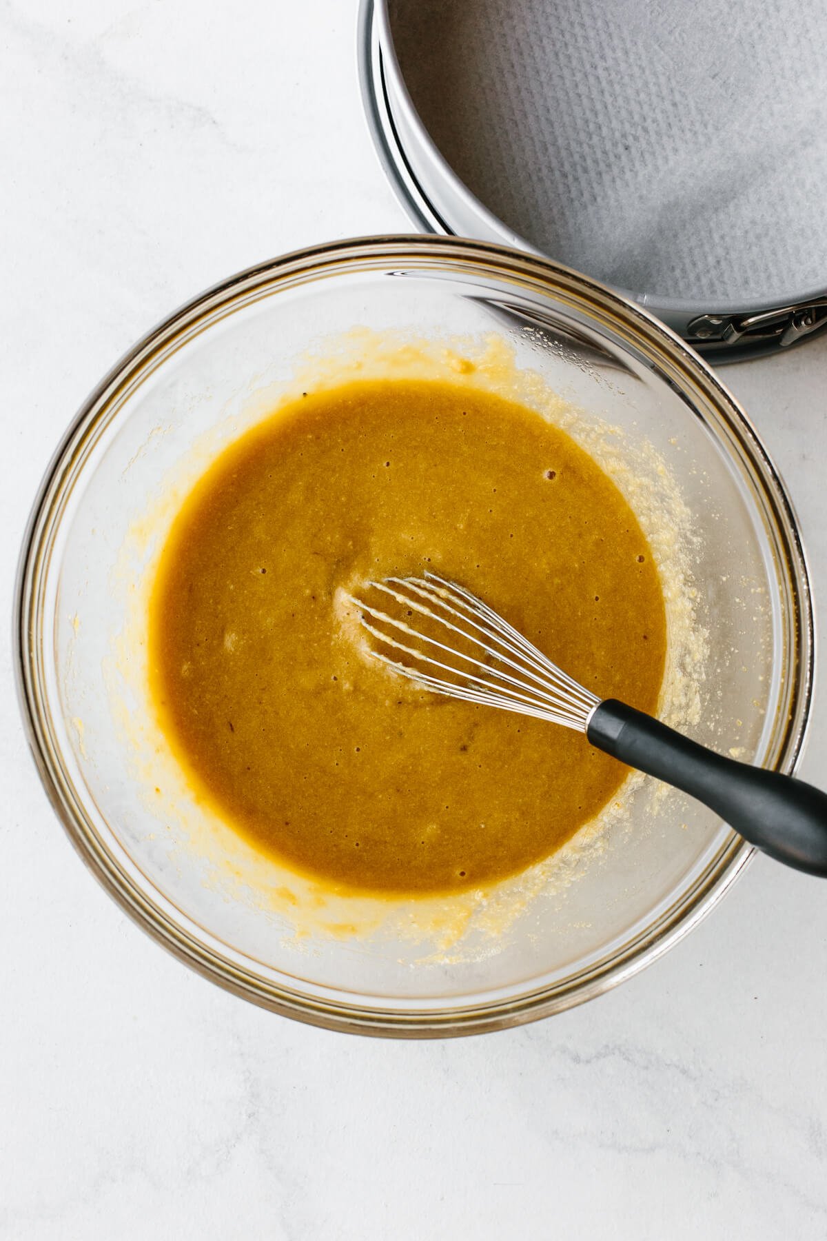 Mixing almond cake batter in a bowl