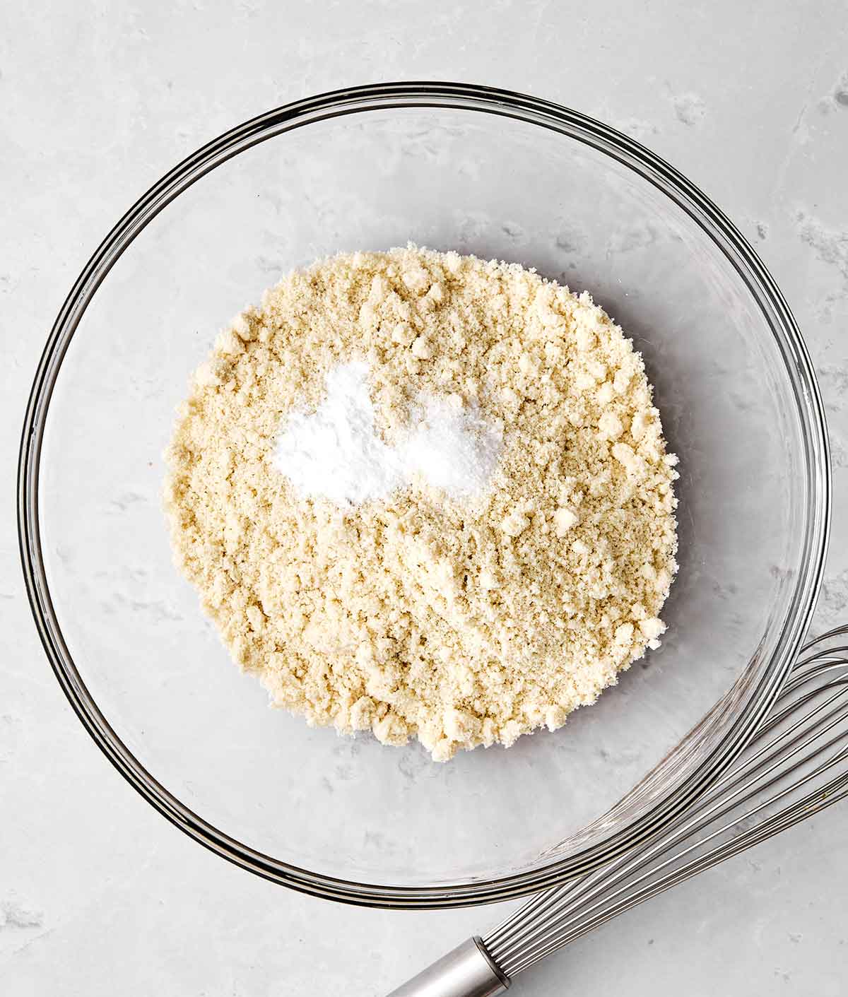 This almond cake is the perfect dessert for any occasion. Serve it plain for afternoon tea or top it with cream and fruit for the holidays! Step one of almond cake: whisk dry ingredients.