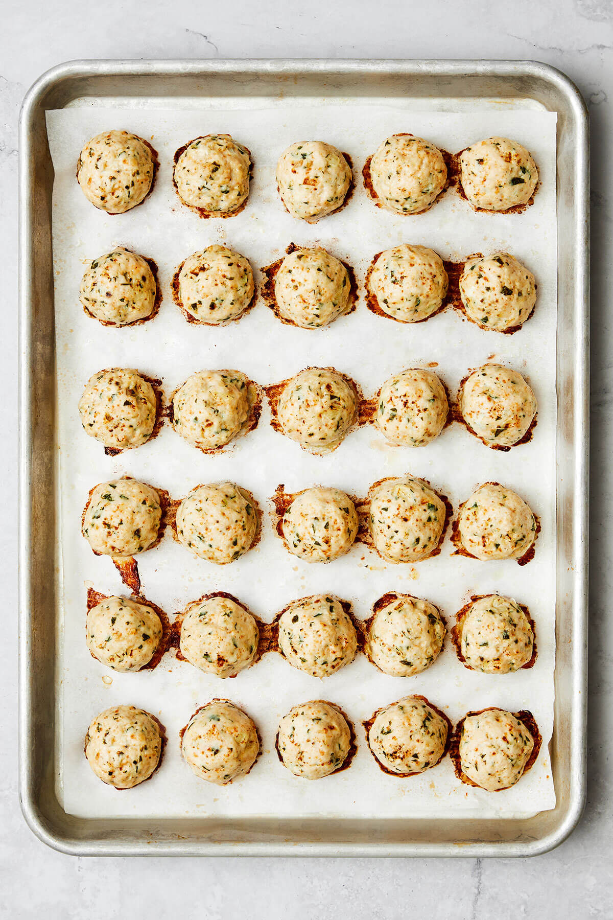 Baked chicken meatballs on a sheet pan