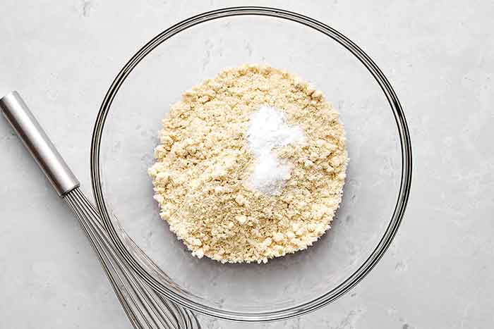 Step one of almond cake: whisk dry ingredients.