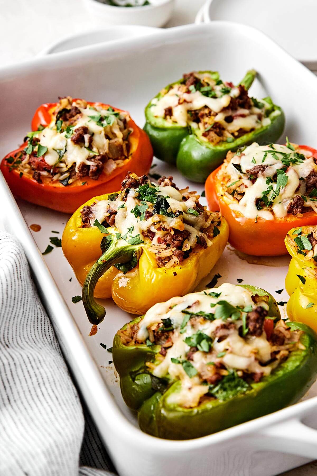 Stuffed peppers are always a family favorite weeknight dinner. This classic version is packed with the best filling — juicy ground beef, fluffy rice, and plenty of veggies seasoned with Italian flavors. Cooked stuffed bell peppers.