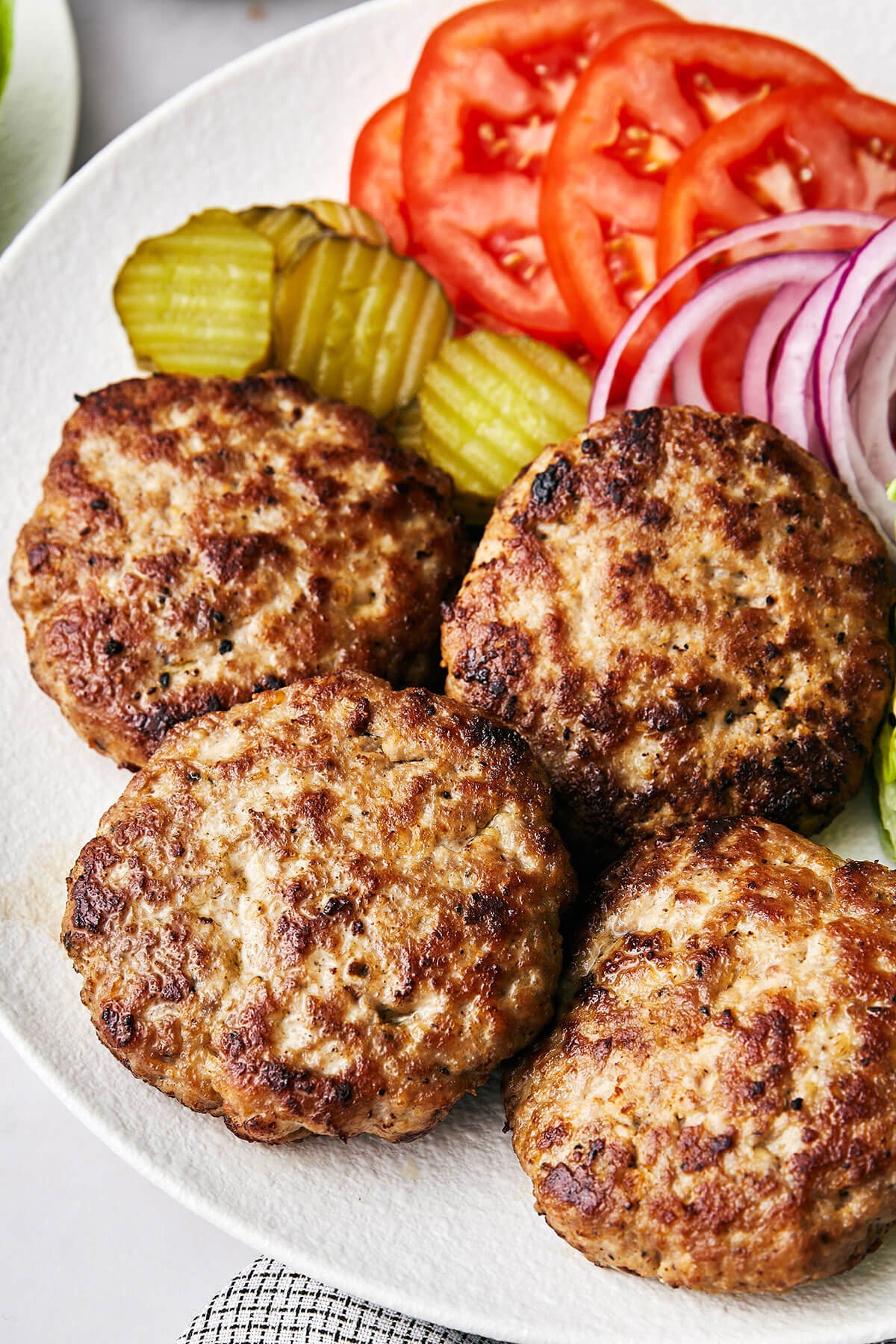 This turkey burger recipe is one you've been looking for all along. The patties are foolproof, perfectly moist, and lend just enough flavor to make the perfect healthy burger. A plate of turkey burgers