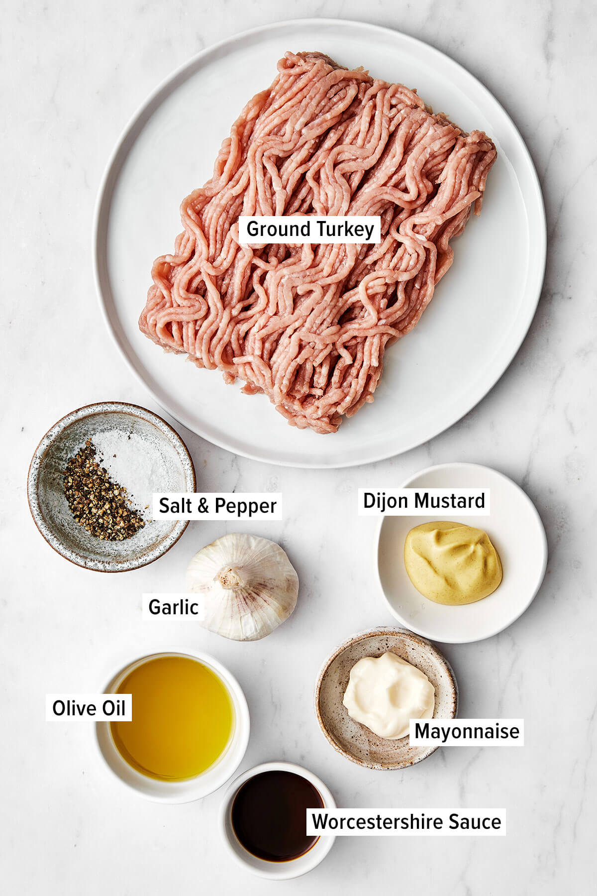 This turkey burger recipe is one you've been looking for all along. The patties are foolproof, perfectly moist, and lend just enough flavor to make the perfect healthy burger. Ingredients for turkey burger on a table