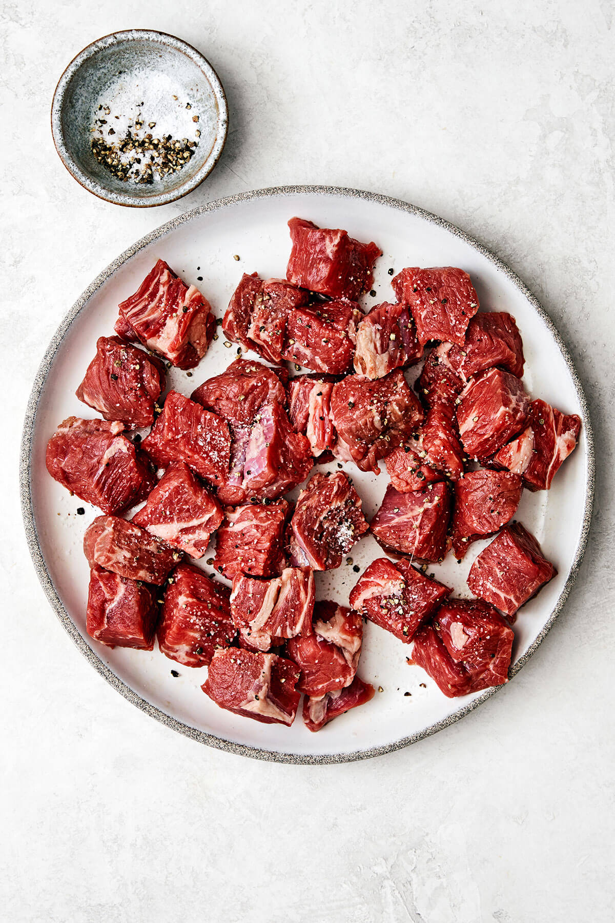 This classic beef stew recipe is a cold-weather one-pot wonder and my favorite for a hearty, comforting, and satisfying meal! Seasoning beef stew chunks