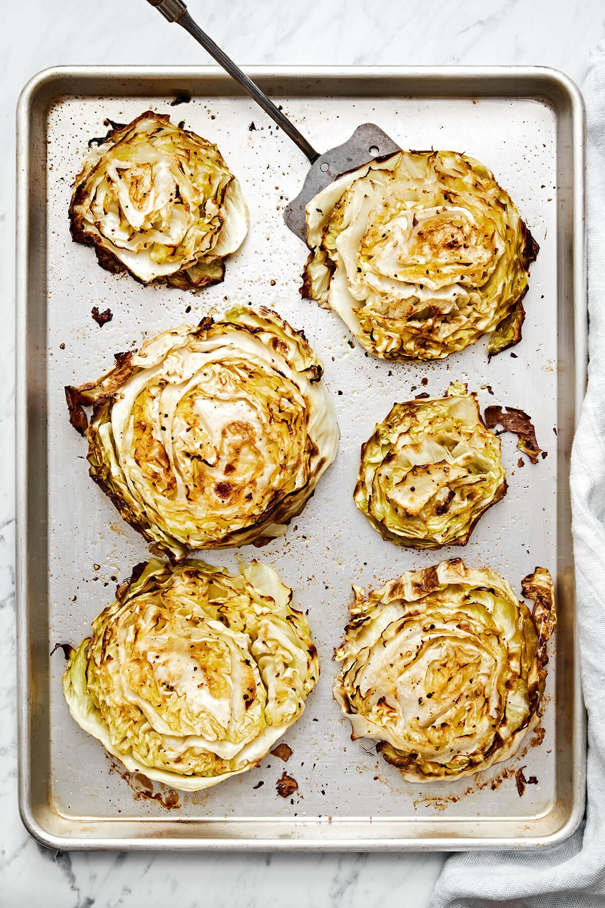 Roasted cabbage steaks are the best way to enjoy this vegetable. They can be served as a side dish or stand-alone meal with various toppings! Cabbage steaks on a sheet pan