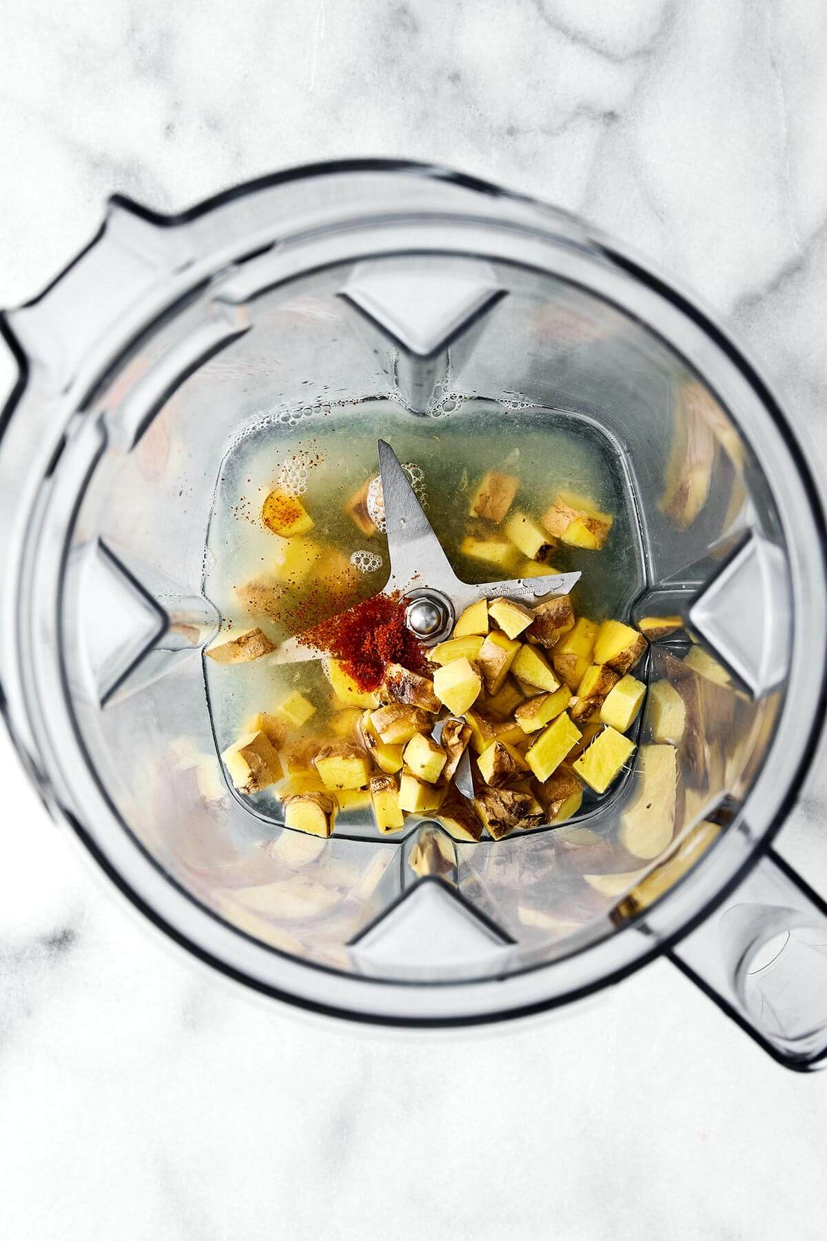 These homemade ginger shots are made easy in a blender, are the perfect anti-inflammatory and immunity booster packed with health benefits, and much more affordable than store-bought wellness shots! Blending ginger shots.