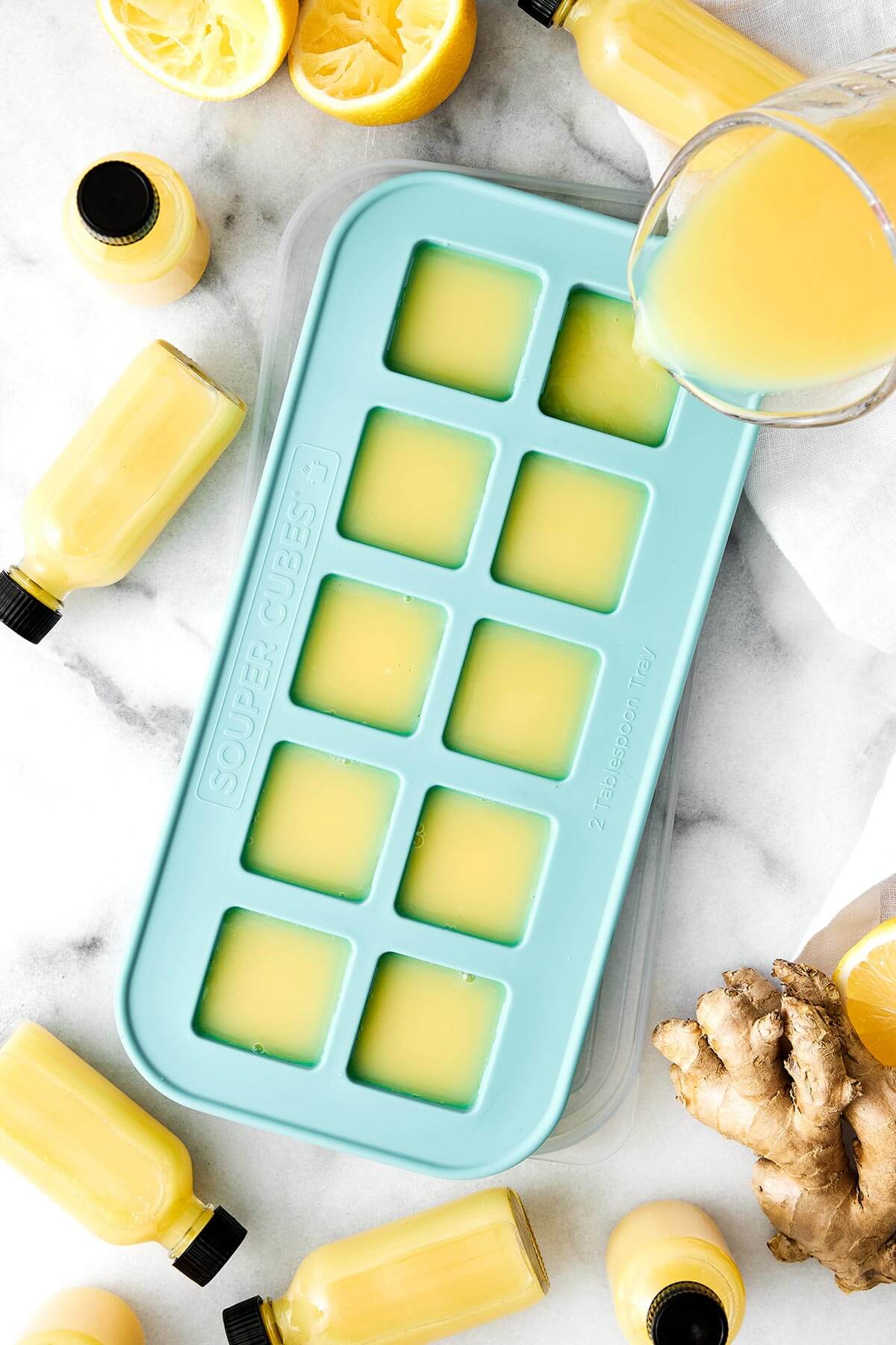 These homemade ginger shots are made easy in a blender, are the perfect anti-inflammatory and immunity booster packed with health benefits, and much more affordable than store-bought wellness shots! Ginger shots in an ice cube tray.