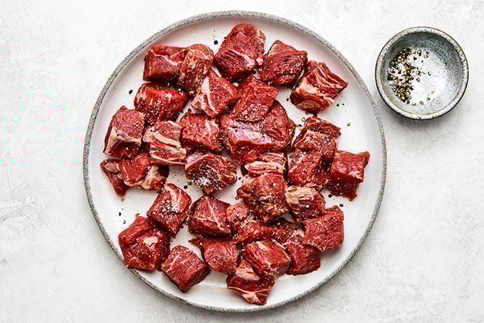 Seasoned beef stew meat on a plate