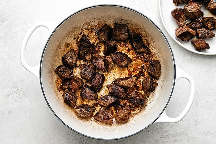 Cooking beef stew meat in a pot