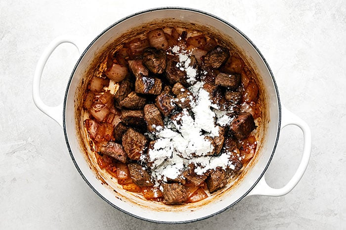 Arrowroot powder and beef stew meat in a pot