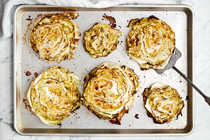 Baked cabbage steaks on a sheet pan